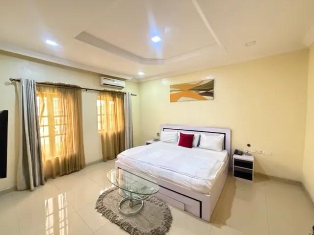 Presidential suite bedroom opening to a terrace at dusk